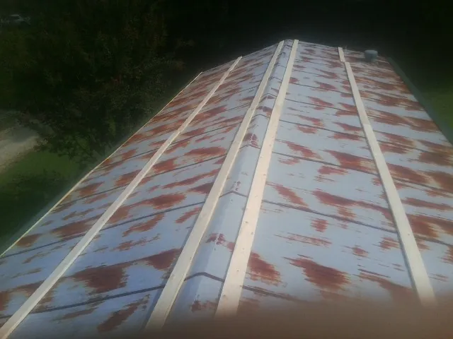 Rusted metal roof panels with new wood purlins before replacement — Storm Damage Roof Repair in Paynes Creek by Roofing Brothers